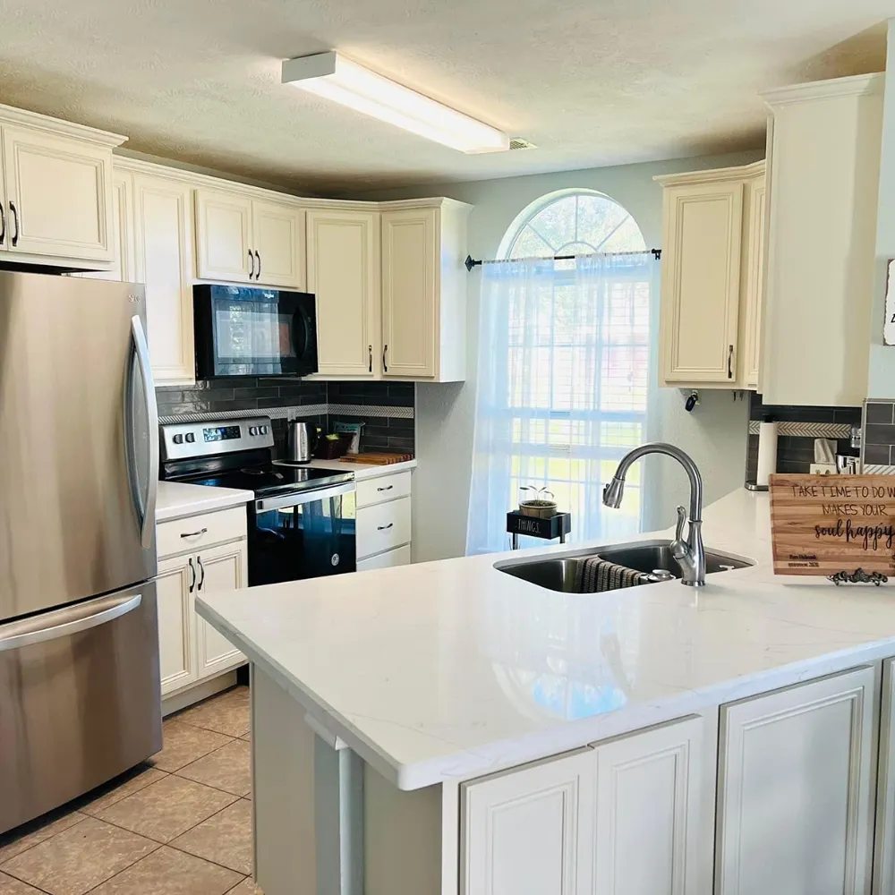 Cream colored cabinets with white counters design